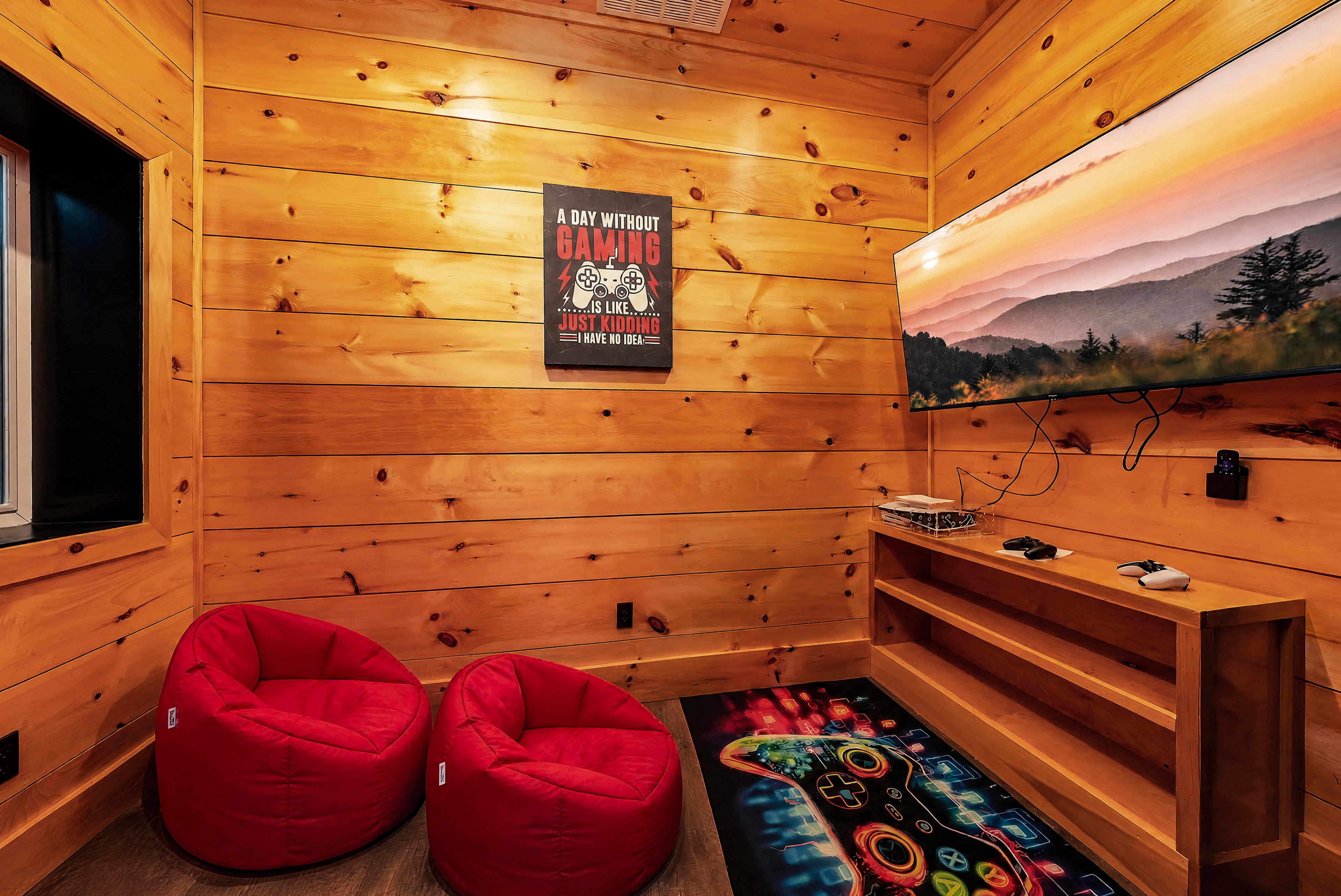 Excalibur pine-walled gaming room with red bean bag chairs and large TV