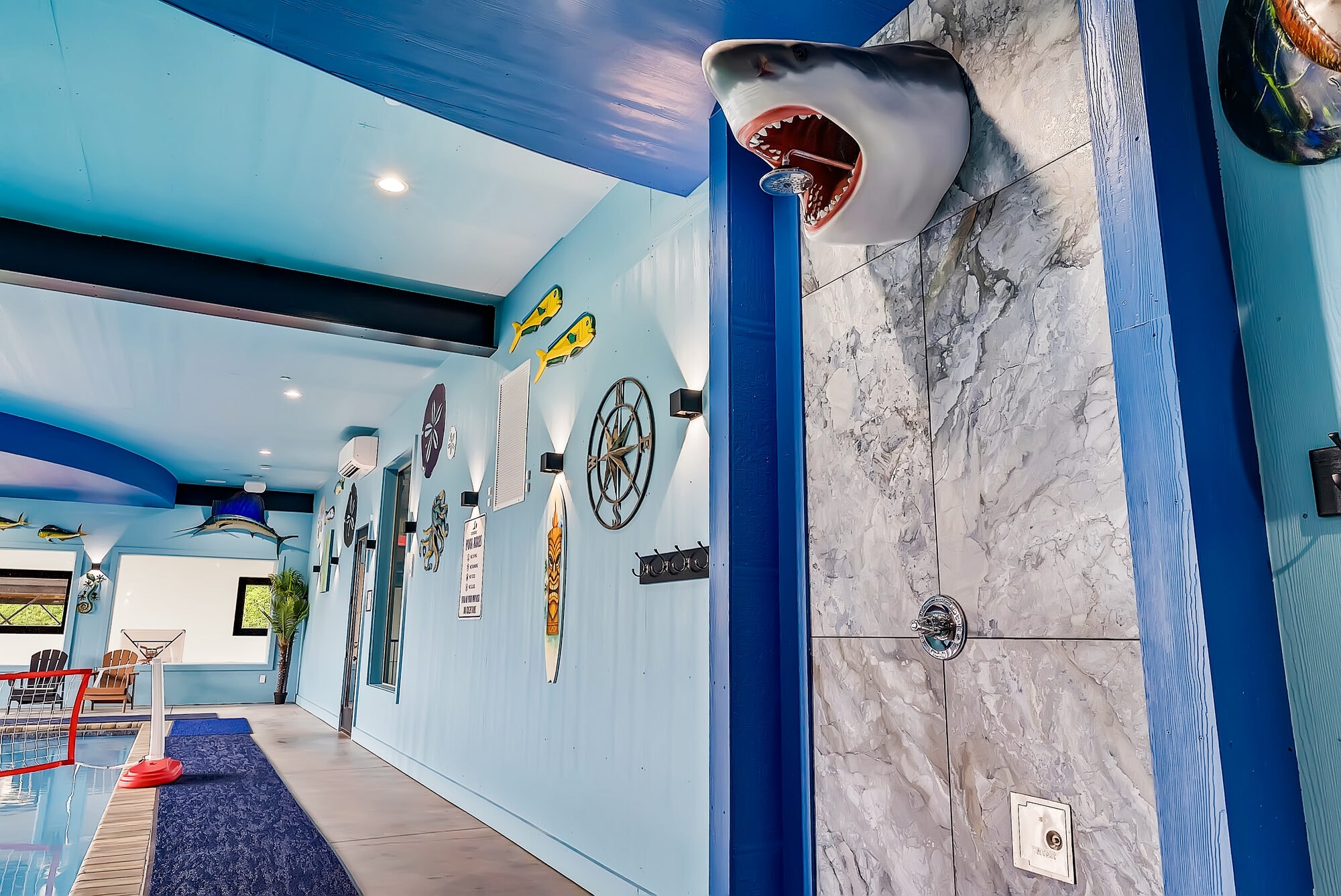 Excalibur pool shark head shower marble tile fish mounts surfboard compass rose nautical decor