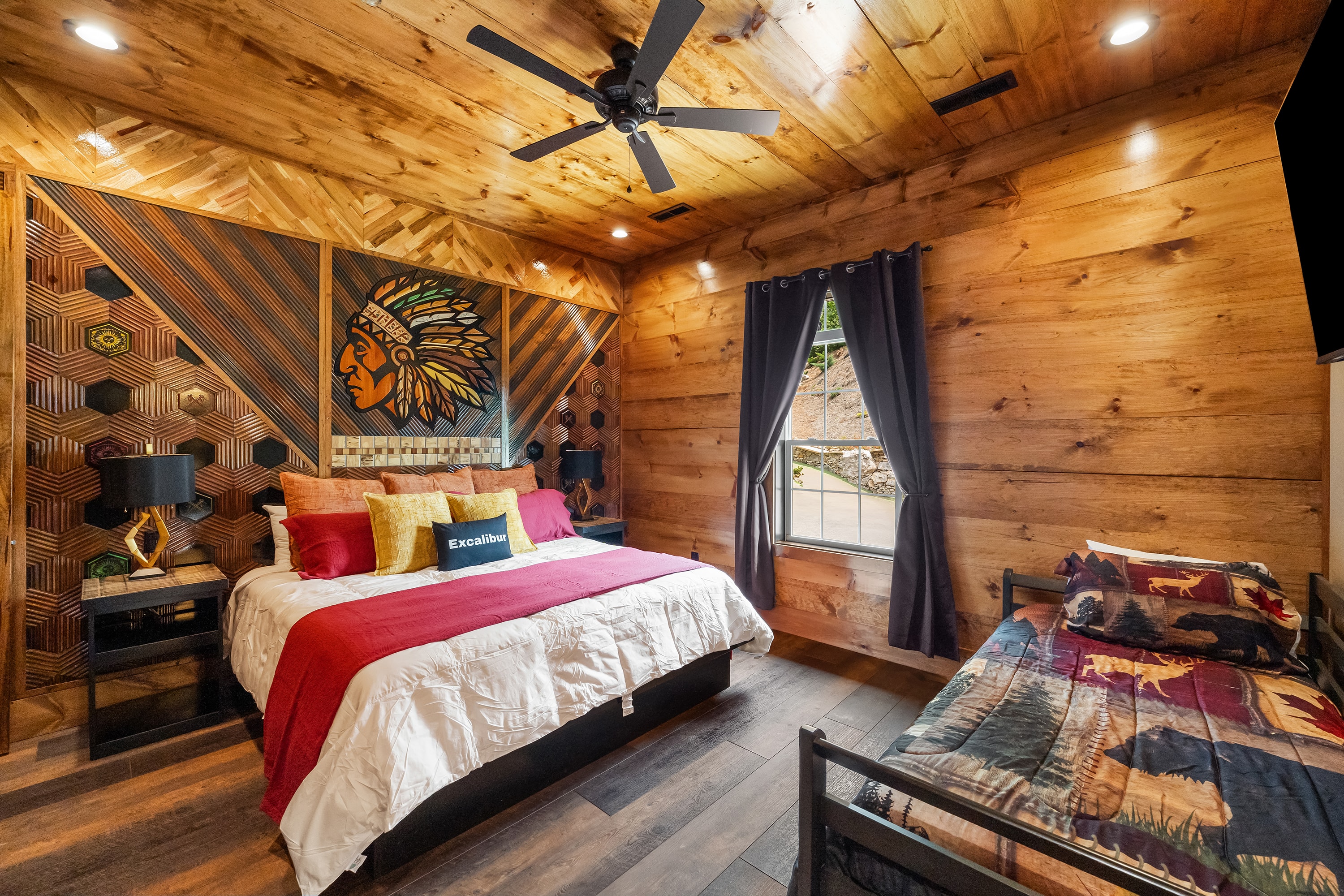 Rustic log cabin bedroom with native american art, upper level king suite