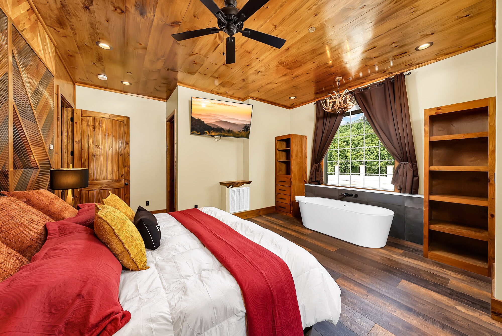 Luxury bedroom with ensuite soaking tub, mountain lodge style
