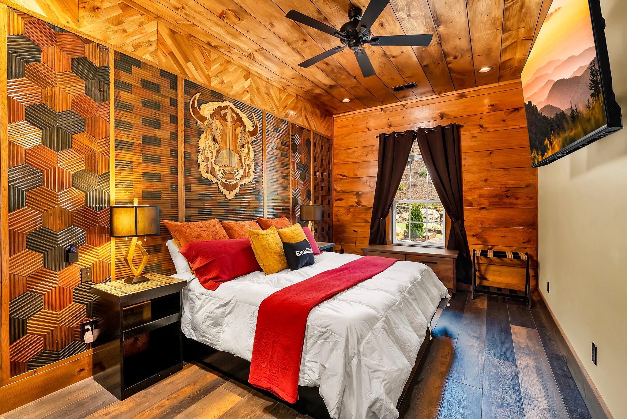 Excalibur bison suite king bed bison wood art headboard warm amber lighting luxury lodge
