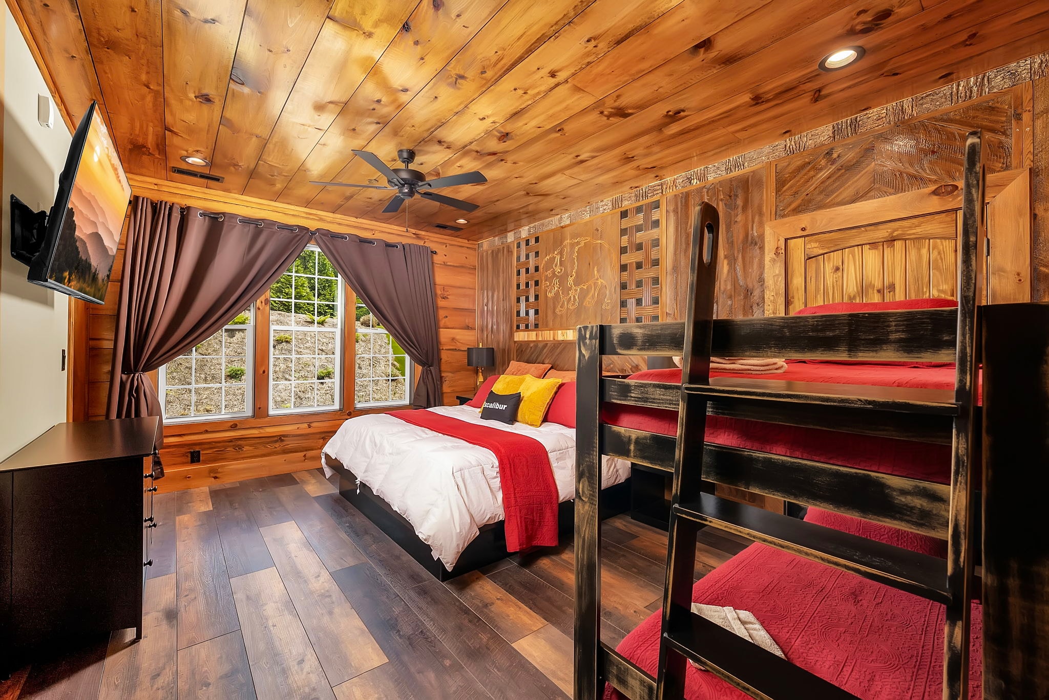 Excalibur suite king bed bunk beds garden view wood paneling luxury lodge