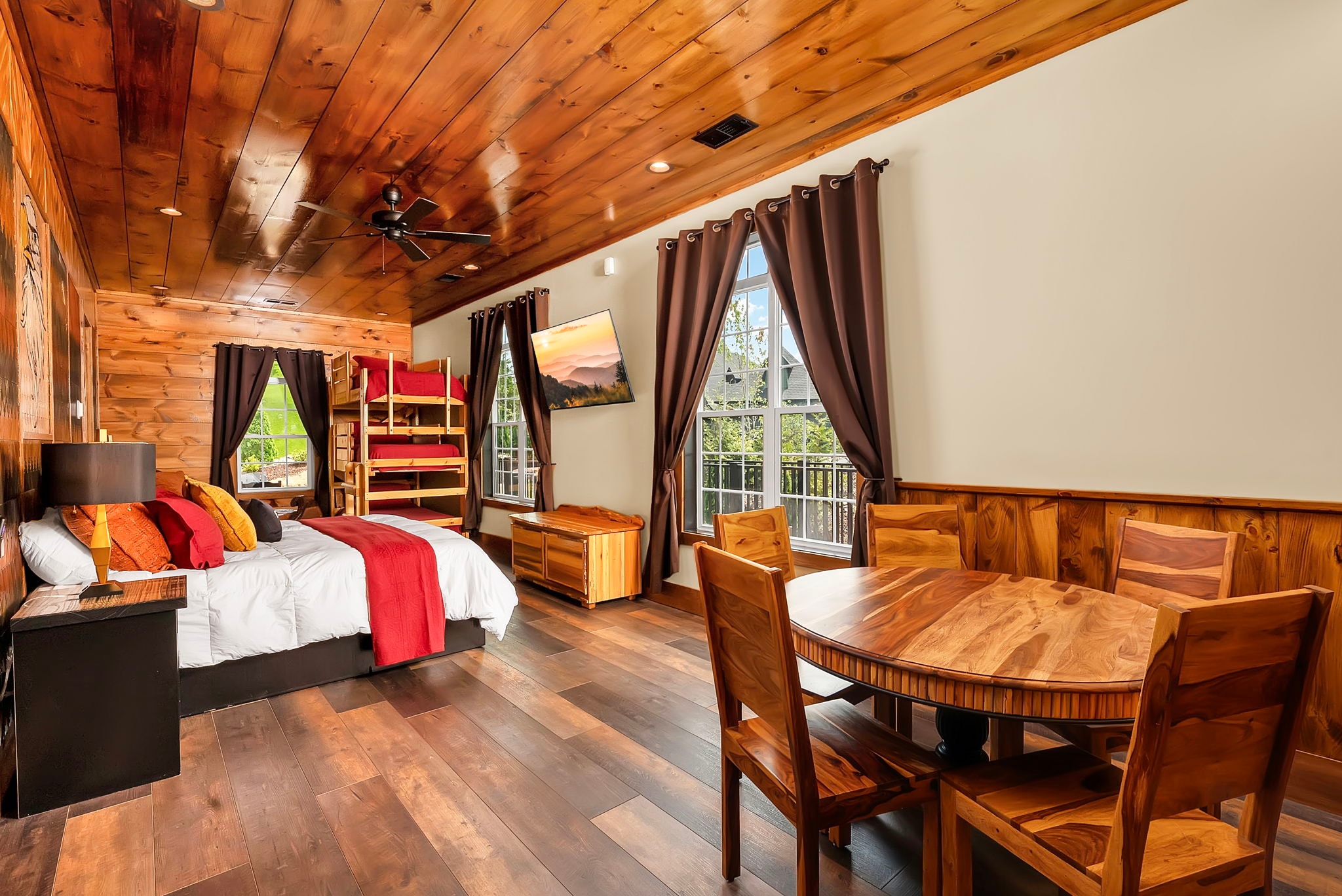 Excalibur suite king bed bunk beds dining nook mountain view wood ceiling luxury lodge