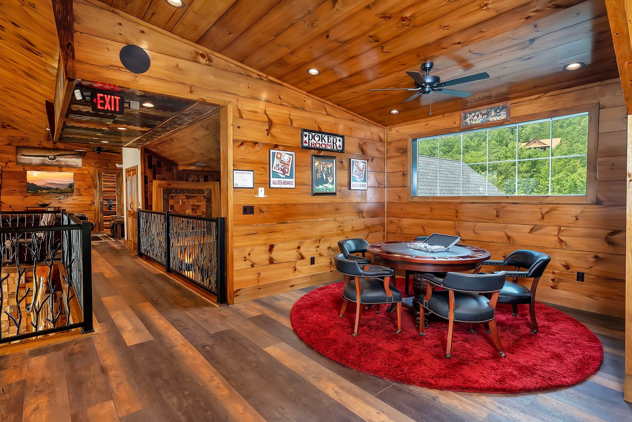 Poker room at Excalibur lodge — cedar walls, red rug, Poker Room sign, and mountain view window