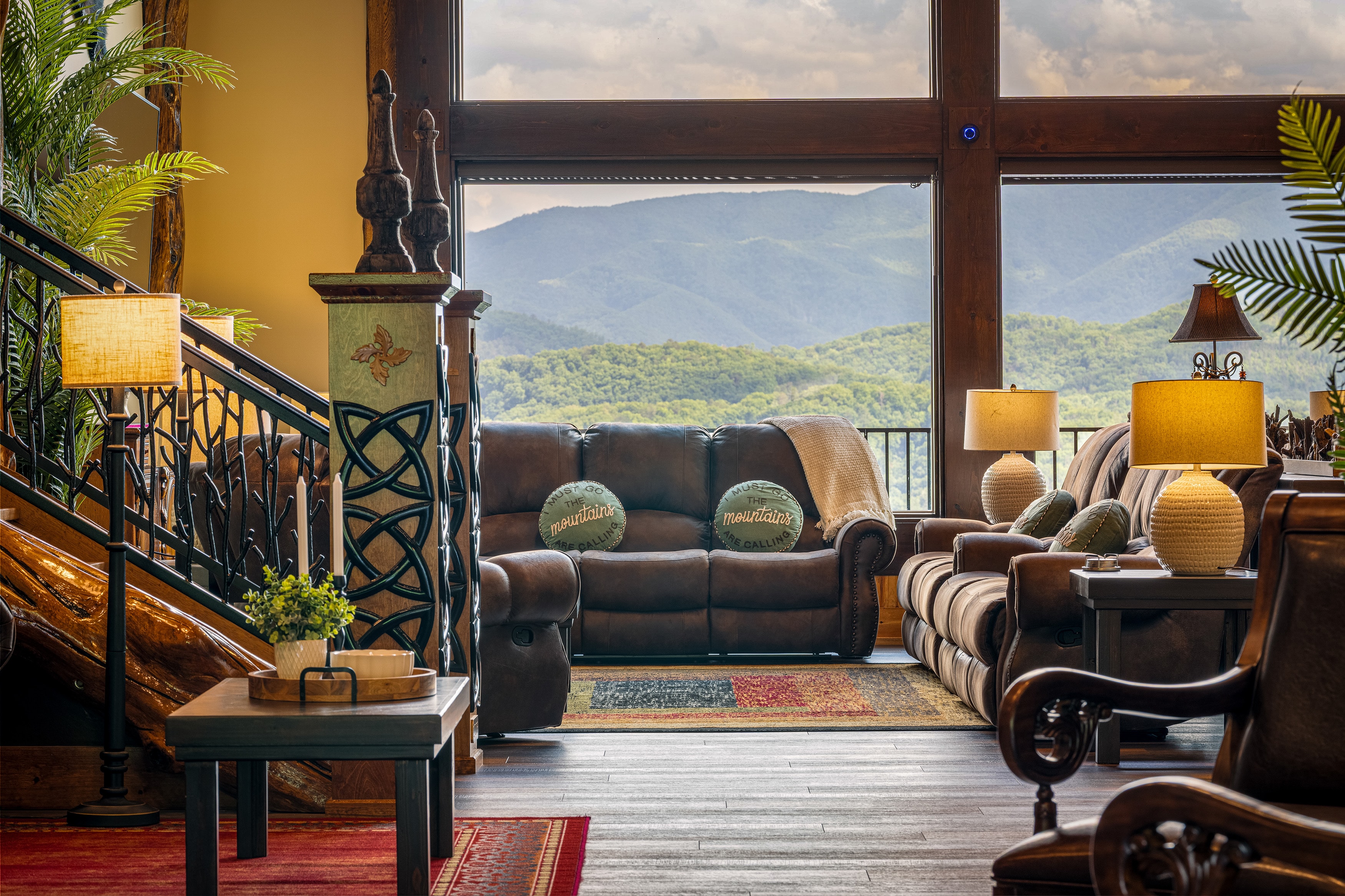 Excalibur great room with floor-to-ceiling mountain view windows and leather seating