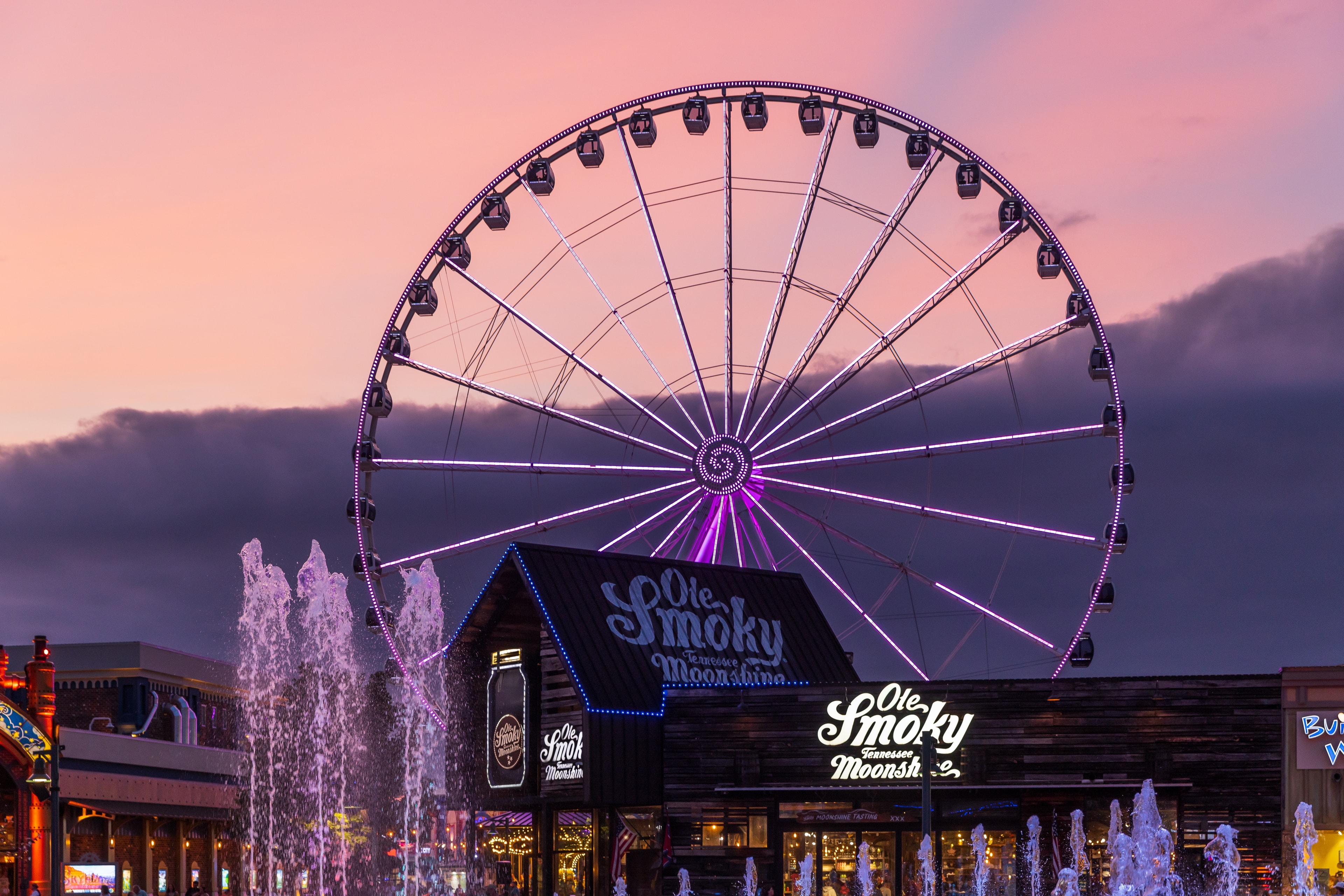 Pigeon Forge The Island Ferris wheel Ole Smoky Moonshine fountains at sunset